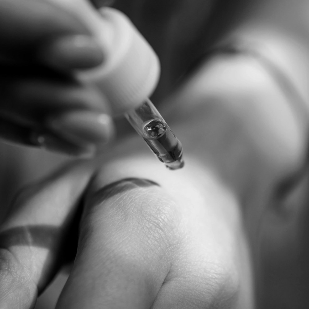 Image of a hand applying perfume on the skin.